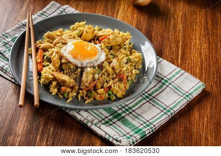 Fried Rice Nasi Goreng With Chicken Egg And Vegetables On A Plate.