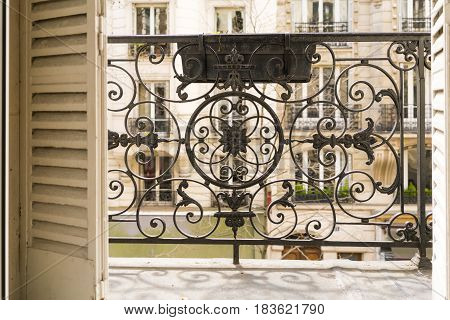 Balcony With Decorative Railing And Shutters In Paris, France