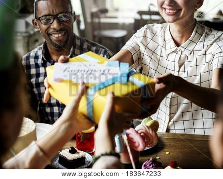 People celebrate birthday party with cake and gift