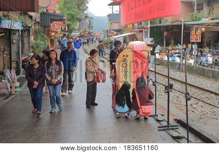 TAIPEI TAIWAN - DECEMBER 5, 2016: Unidentified people fly sky lantern in Shifen town. Shifen is an old railroad town and popular tourist destination.