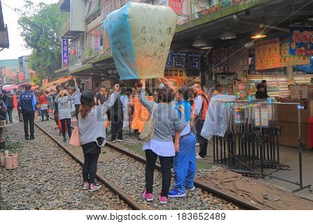 TAIPEI TAIWAN - DECEMBER 5, 2016: Unidentified people fly sky lantern in Shifen town. Shifen is an old railroad town and popular tourist destination.