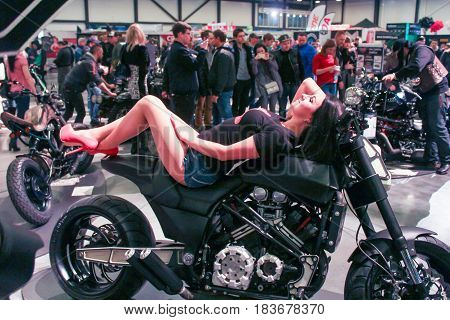 St. Petersburg Russia - 15 April, A fashion model lying on a motorcycle,15 April, 2017.
International Motor Show IMIS-2017 in Expoforurum.
Models on motorcycles presented at the motor show.