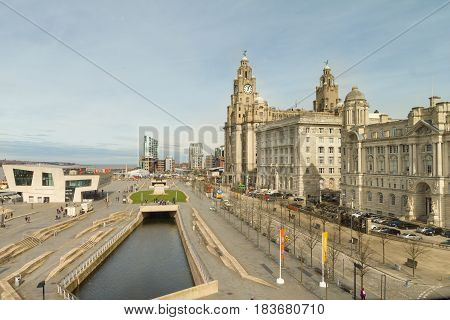 Liverpool, England - April 3, 2017: View of the Pier Head, the Beatles Store and the Three Graces. Previously called George's Pier Head, the are is located in the city centre of Liverpool.