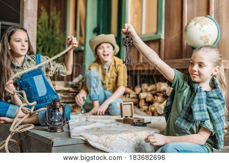 Adorable Little Kids Travelers Sitting Together With Map On Porch