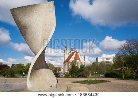 MAGDEBURG, GERMANY - APRIL 19, 2017: Flag monument and St. Johannis-Church on the banks of the river Elbe in Magdeburg. The St. Johonnis-Church in Magdeburg is a former church building and has been used since 1999 for concerts and events.