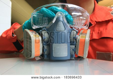 Multi-purpose respirator half mask for toxic gas protection.The man prepare to wear Multi-purpose respirator half mask.