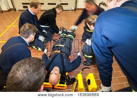 Hamburg, Germany - February 07, 2013: German firefighter team in an exercise with a injured in a stretcher