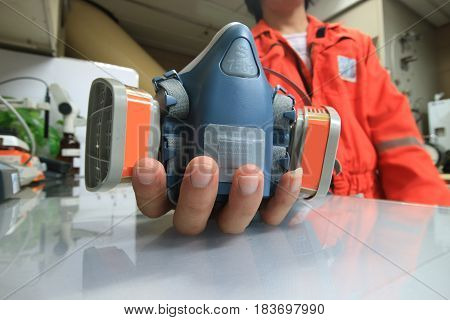 Multi-purpose respirator half mask for toxic gas protection.The man prepare to wear Multi-purpose respirator half mask.