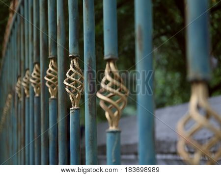 Metal fence detial in green and gold