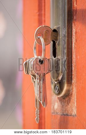 Key in keyhole on door. Rusty keys in old door lock. Selective focusing