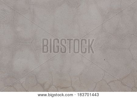 Gray Wall with a lot of cracks