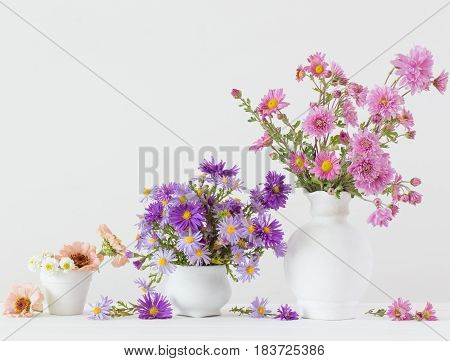 flowers in a ceramic vase on a white background