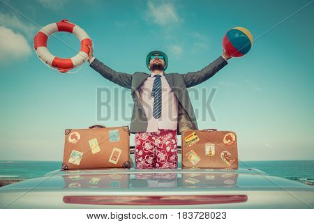 Businessman Standing On A Beach Near Car