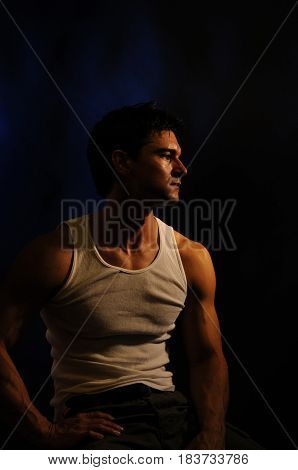 The attractive man is looking off to the side.