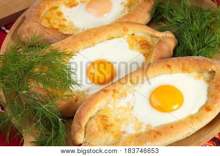 ajarian khachapuri dish of Georgian cuisine, Georgian national pastry, which is a flatbread with cheese. baked in the shape of boats and pour the egg