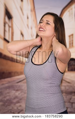 Beautiful lady Suffer crick after workout in the street.