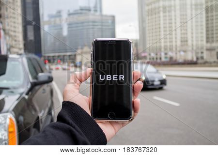 Chicago,IL,USA,Feb-21,2017,Man holding a smartphone with an open Uber app in the city
(for editorial use only)