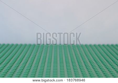 Colorado, USA - April 27, 2017: Studio shot of green LEGO baseplate with light blue background.