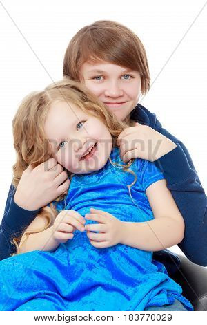 Big brother teen holds the hands of his beloved younger sister.Isolated on white background.