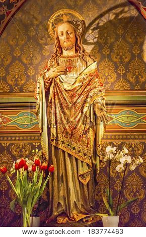 AMSTERDAM, NETHERLANDS - MARCH 30, 2017 Jesus Christ Sacred Heart Wooden Figure De Krijtberg Church Amsterdam Holland Netherlands. De Krijtberg may be the most beautiful church in Amsterdam.