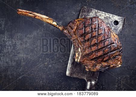 Barbecue dry aged Wagyu Tomahawk Steak as close-up on old metal sheet