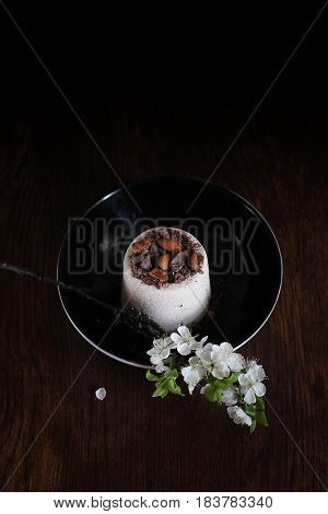 Paskha is a festive dish made in Eastern Orthodox countries. Curd Easter and bunch of flower in close up on the dark background. The cottage cheese easter