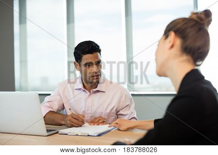 Business people discussing contract during meeting in conference room