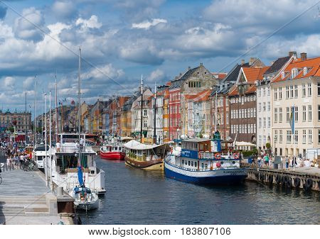 COPENHAGEN DENMARK - JULY 31 2016: Summer view of the famous Nyhavn with its colorful buildings