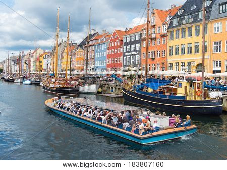 COPENHAGEN DENMARK - JULY 31 2016: Summer view of the famous Nyhavn with its colorful buildings