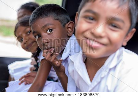 KANDY SRI LANKA - MARCH 17 2016: Children smiling on the car before go to school and looking at camera on March 17 2016 in Kandy Sri Lanka.