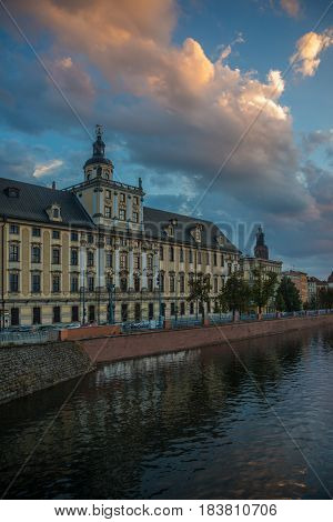 Wroclaw view: river Oder (or Odra) and University of Wroclaw against beautiful evening sky with clouds.