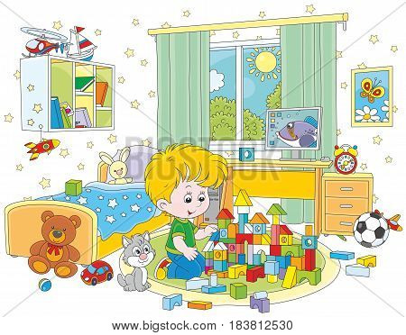 Little boy playing with bricks in his room