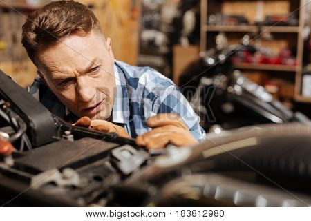 Lovely lines. Capable diligent hardworking man working on his gorgeous vintage vehicle by fixing all mechanisms and making it great again