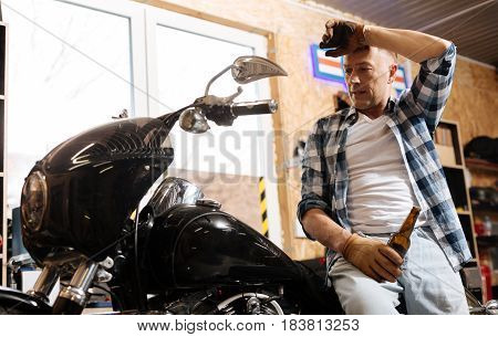 Great day. Qualified able nice mechanic taking a look at the bike he repairing all day and enjoying the view while resting on it