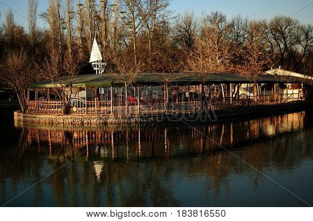 Cozy winter park with a lake. Beautiful park
