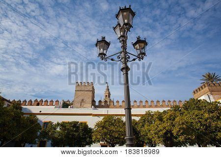 Seville cathedral Giralda tower from Alcazar of Sevilla Andalusia Spain. The Alcázar of Seville is a royal palace in Seville Spain originally developed by Moorish Muslim kings.