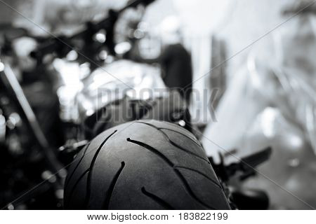 Art of riding fast. Modern professional rubber shoes of a vehicle lying in garage and lines on a tire forming a special pattern