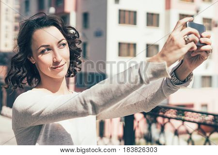 The Girl Poses On The Phone, Photos Herself, Makes A Photo For Social Networks.