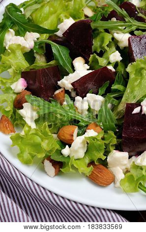 Salad vinaigrette with beets lettuce arugula feta and almonds
