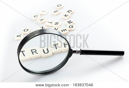 Loupe and Alphabet Tiles Arranged in a Word Truth