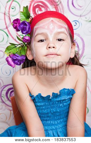 Portrait Of A Cute Child With Flowers