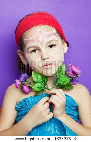 Portrait Of A Cute Child With Flowers
