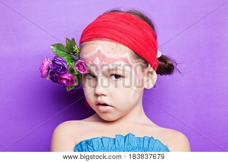 Portrait Of A Cute Child With Flowers
