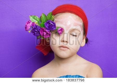 Portrait Of A Cute Child With Flowers