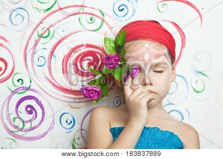 Portrait Of A Cute Child With Flowers