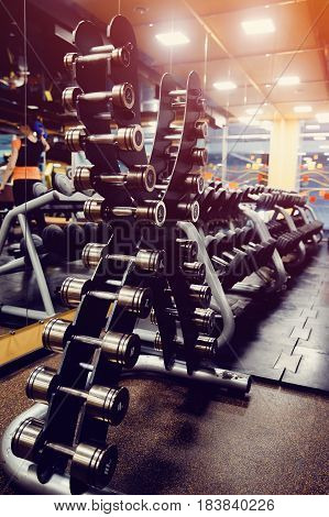 Sports equipment dumbbell rests in a row. high contrast and monochrome color tone.