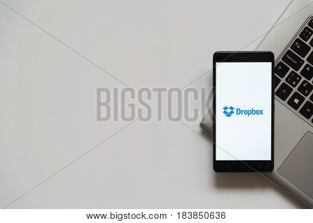 Bratislava, Slovakia, April 28, 2017: Dropbox logo on smartphone screen placed on laptop keyboard. Empty place to write information.