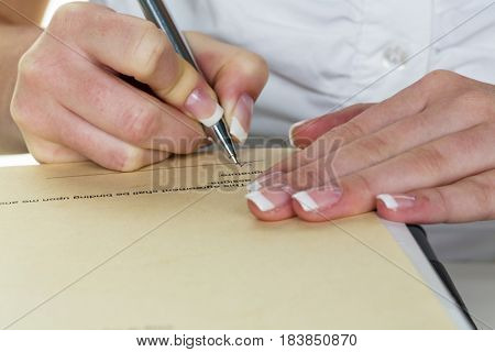 hand with fountain pen signing contract