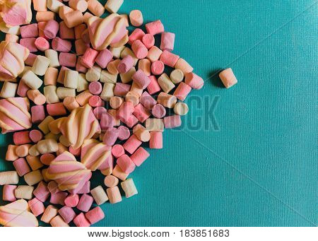 Marshmallows Background or texture of colorful mini marshmallows Handful of colorful marshmallows on a blue background
