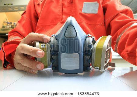 Multi-purpose respirator half mask for toxic gas protection.The man prepare to wear Multi-purpose respirator half mask.